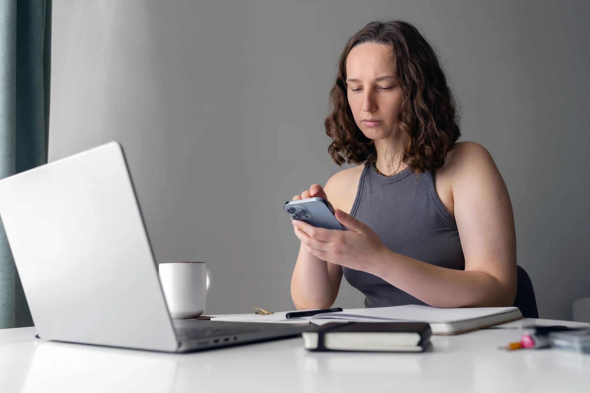An employee reviews a short training module on her phone during a break at the office